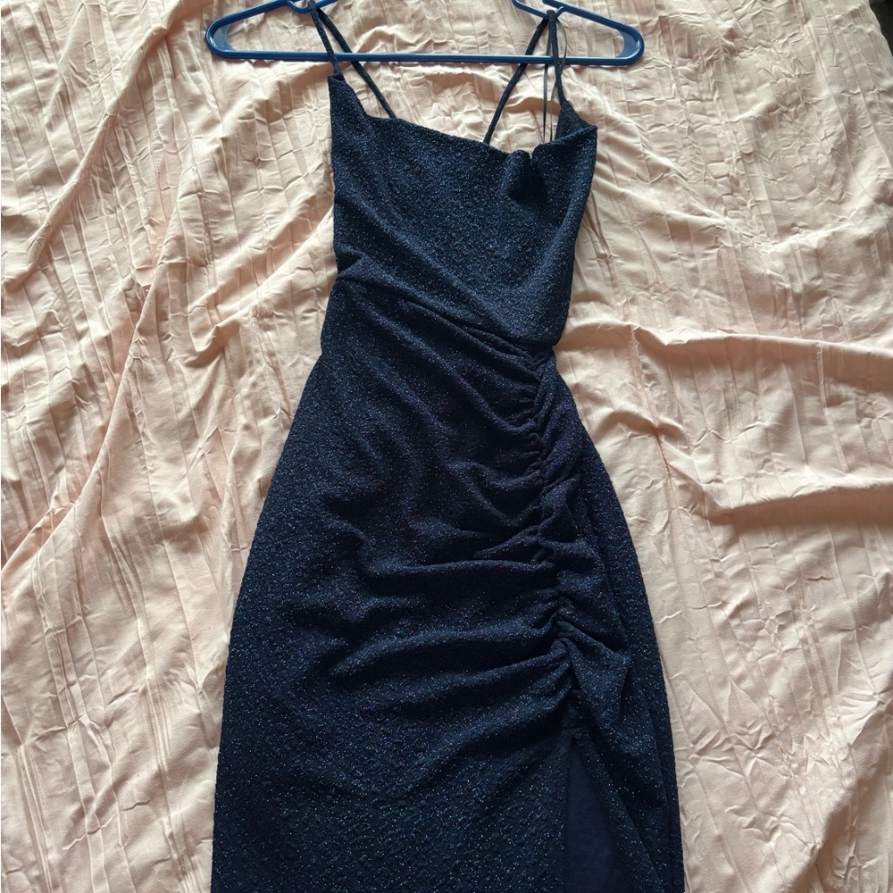 Glittery navy blue prom dress with left leg slit.